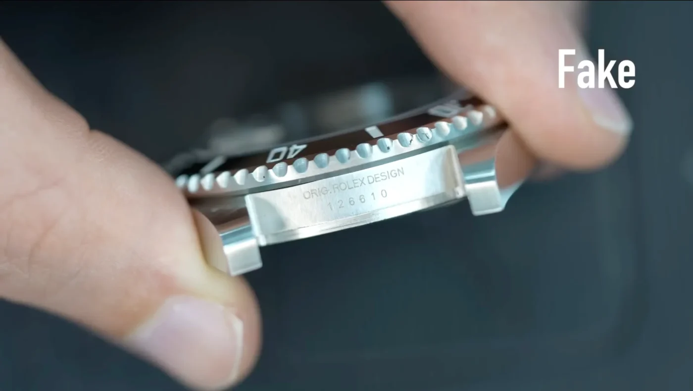 Close-up of Submariner super clone rehaut engraving at 6 o'clock showing laser-etched serial number and repeating text